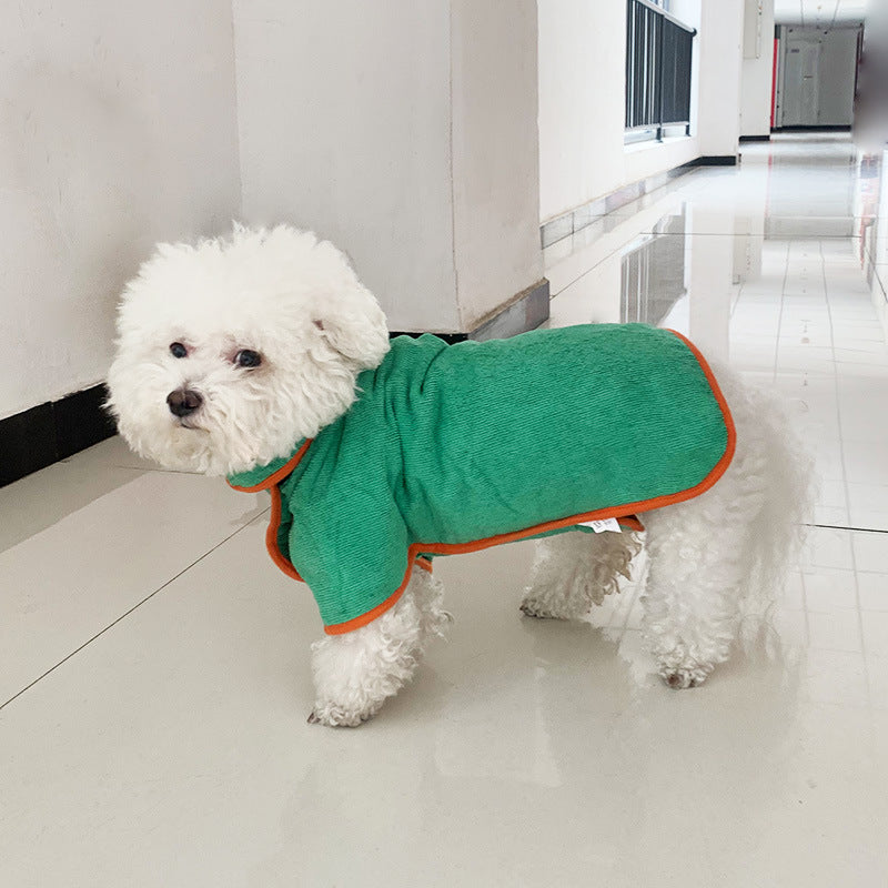 Small white dog wearing a microfibre drying coat indoors